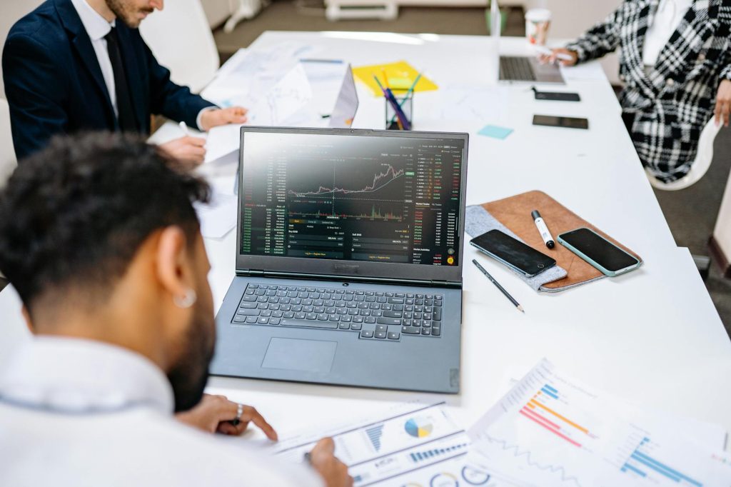 Financial growth charts displayed on a laptop screen in a business setting