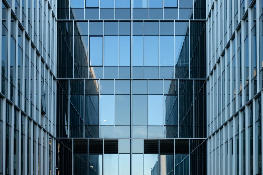 Contemporary glass office building facade reflecting urban architecture