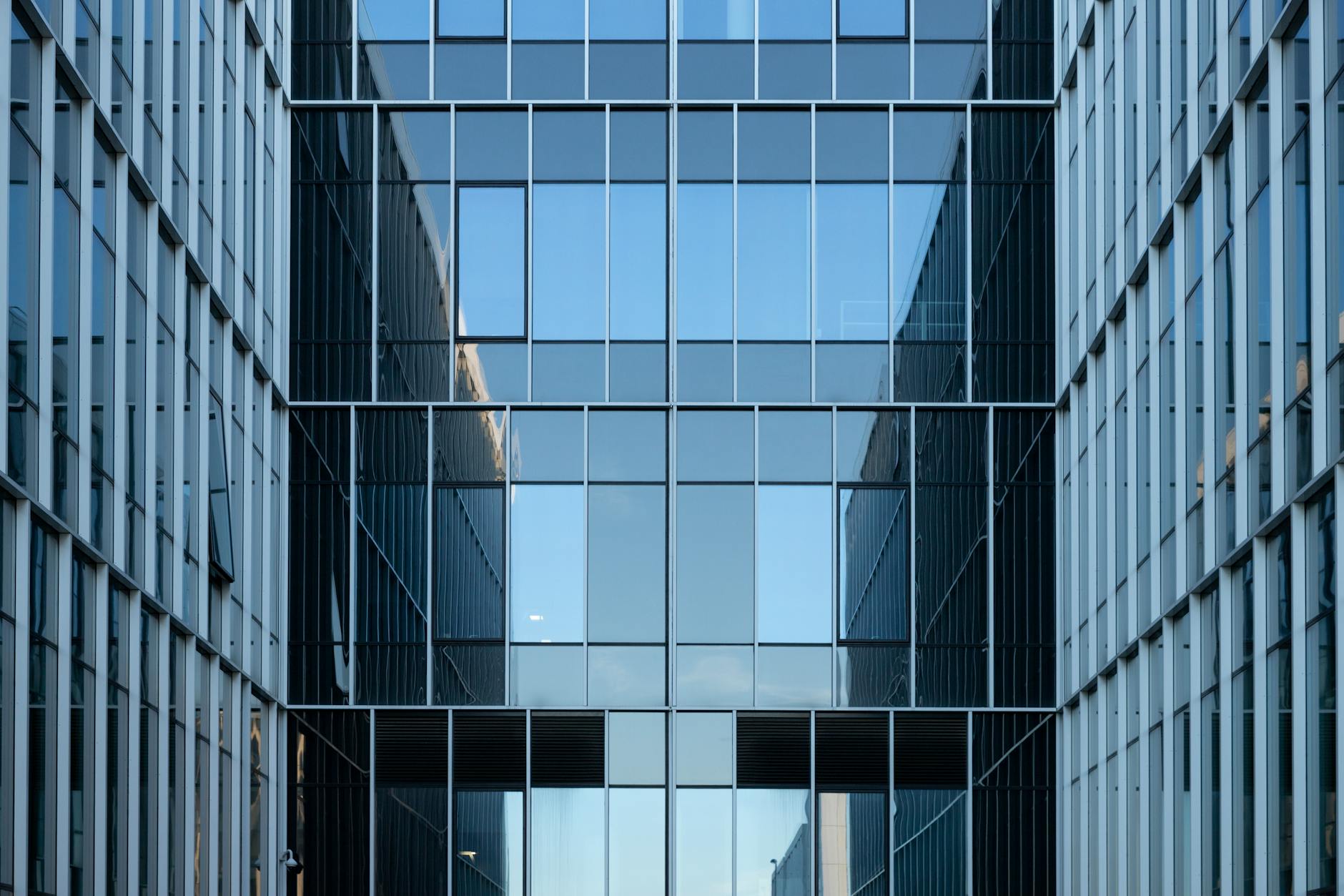 Contemporary glass office building facade reflecting urban architecture