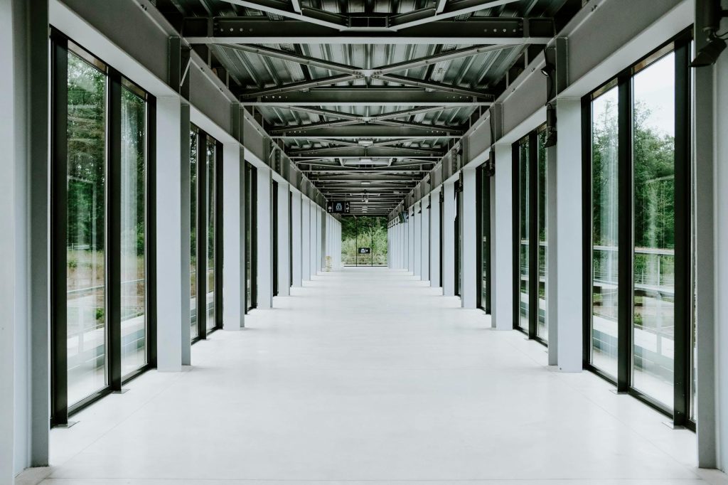 Sleek and modern corridor showcasing transparent walls and open structural design